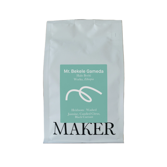 White coffee bag with a green label on a beige background