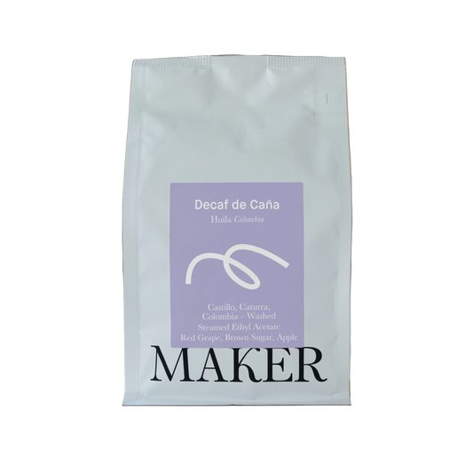 Coffee bag labeled 'Decaf de Caña' by 'MAKER' on a beige background