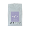 Coffee bag labeled 'Decaf de Caña' by 'MAKER' on a beige background