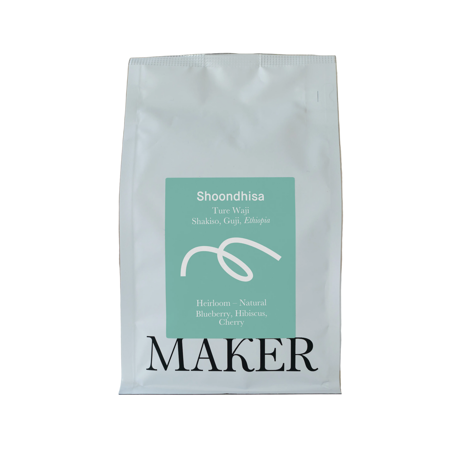 White coffee bag with teal label featuring 'Shoondhisa' and 'Maker' on a beige background