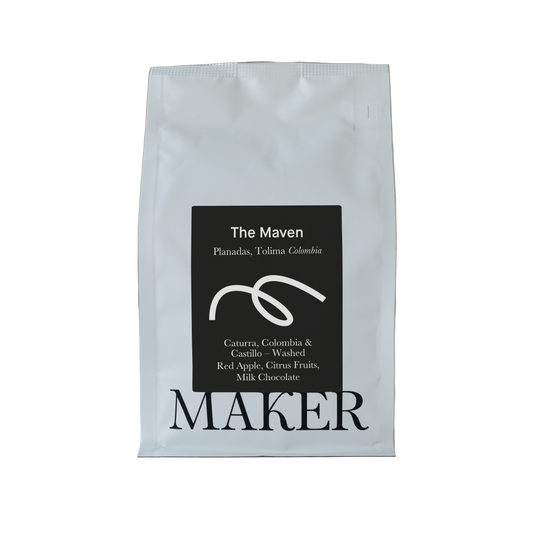 White coffee bag with black label featuring 'The Maven' and 'Maker' on a beige background