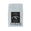 White coffee bag with black label featuring 'The Maven' and 'Maker' on a beige background